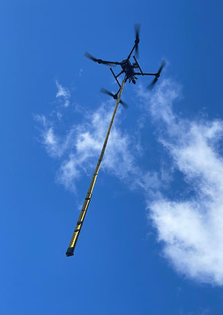 Under drone photo with long pole