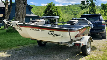 River fishing boat in driveway