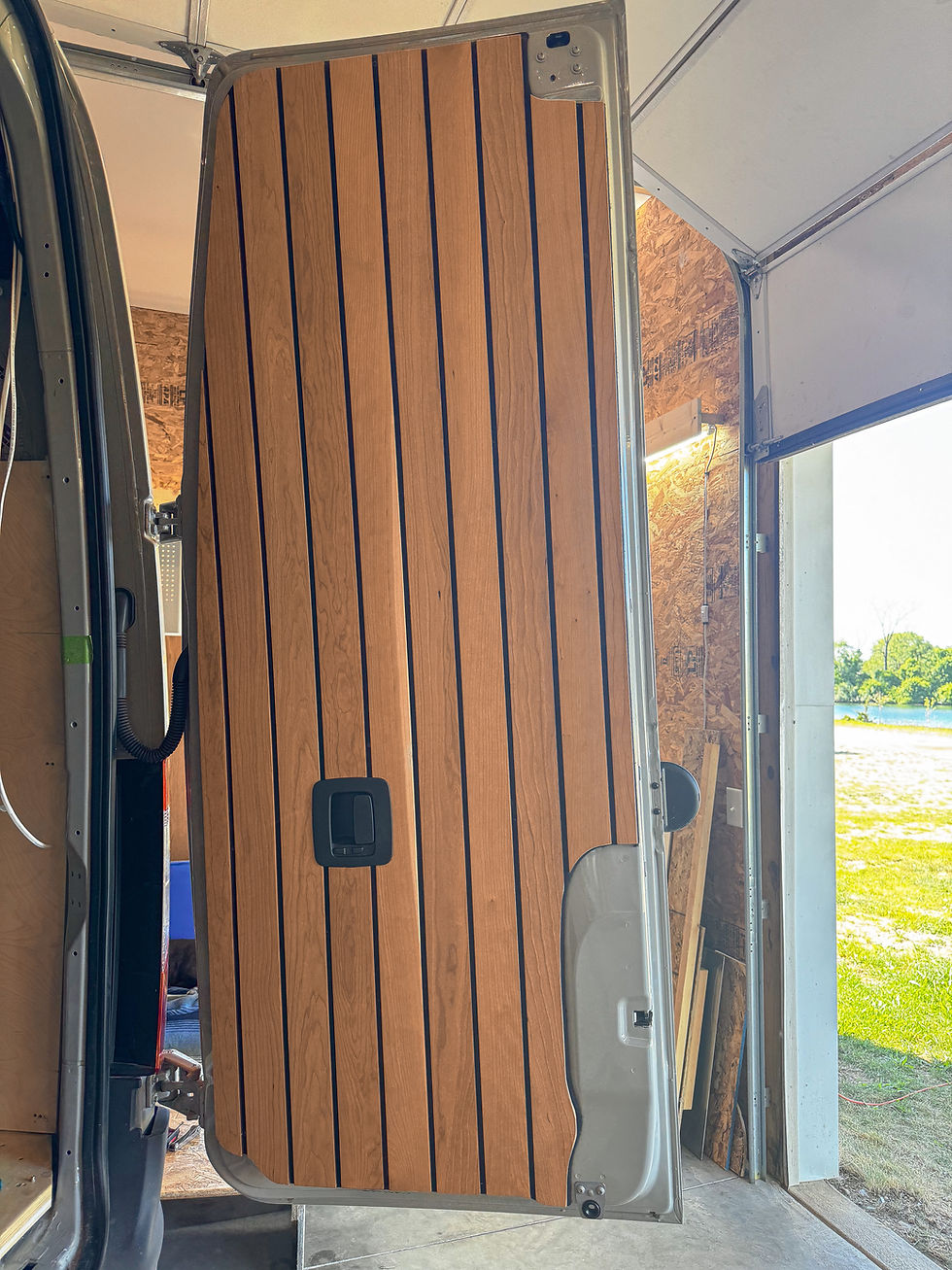 Off grid adventure van interior, wood paneled door open to lake
