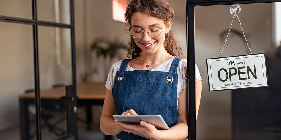 Happy waitress standing at restaurant entrance holding digital tablet to check the reserva
