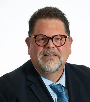 Portrait of man in suit with glasses