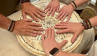 pairs of hands on a frame drum