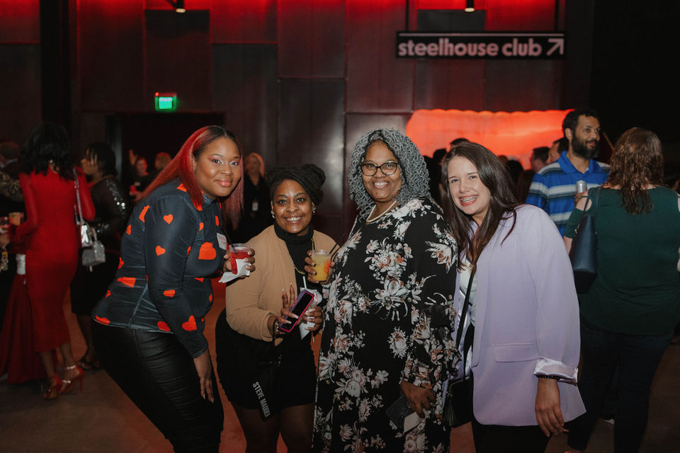 Signature Performance team members socializing at a company evening event
