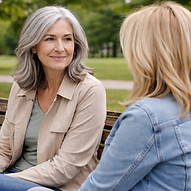 Two friends chatting on a park bench.png