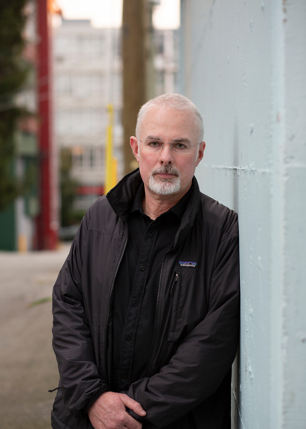 A man leaning against building