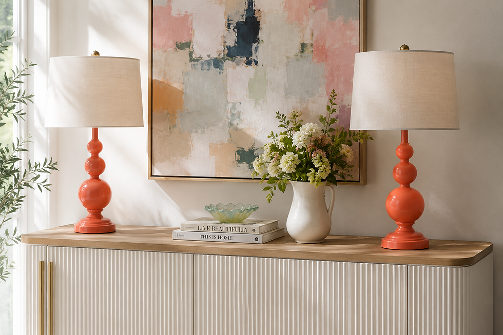 Bright entryway console with coral lamps, abstract pastel art, flowers, books reading LIVE BEAUTIFULLY and THIS IS HOME, sunlit and calm