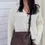 Thumbnail: Anastasia woven crossbody bag worn crossbody on model, front view