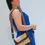 Thumbnail: Woman wearing Kira two-tone vegan leather crossbody bag, shows adjustable wide strap for crossbody style