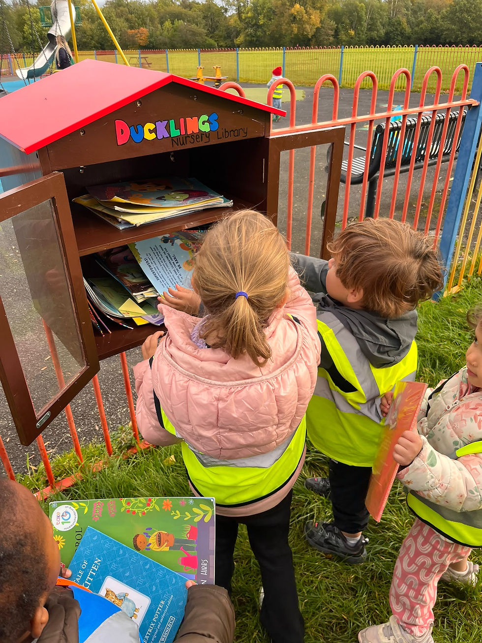 Children using the Ducklings Library at the David Lewis Play Area