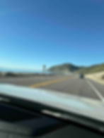 A view from the car driving north on the Pacific Coast Highway.