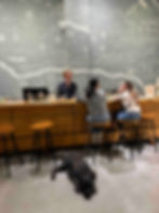 The wine bar at The Valley Project in front of a massive chalk art wall.