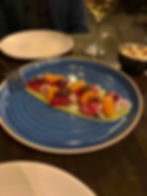 A sashimi dish at the Lark on a blue plate.
