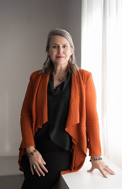 Amelia Psmythe Seger in a bright orange jacket - Amelia is an Executive coach specializing in leadership development