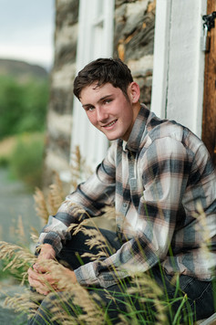 boy in plaid shirt with old building