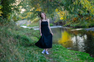 girl on riverbank in black dress