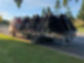 Crane truck loaded with bulldozer parts