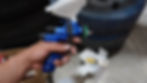 a man preparing to use a paint spray gun tool