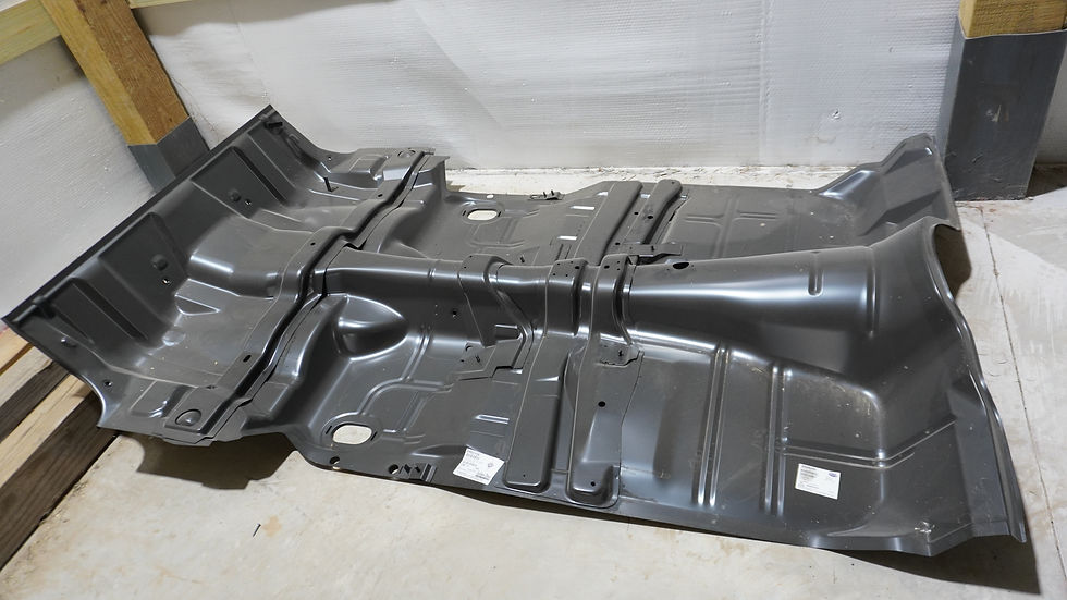 a repaired black car panel sitting on concrete