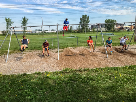 Participants playing on the swings at a local park during an outdoor S.Au.S. activity.