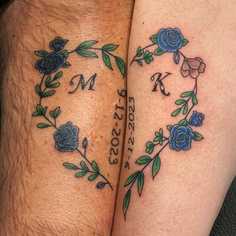 Heart-shaped floral tattoo with initials.