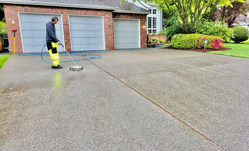 Photo of Nick, owner of Superior Softwash, cleaning a driveway.