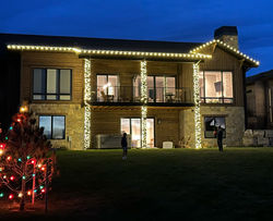 Two-Story White Lights, Trim and Pillars, Multi-colored lit Christmas tree