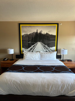 Cozy and inviting king-size bed with fresh bedding at Super 8 Edmonton South.