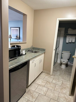 Super 8 Edmonton South room amenities include a mini fridge, microwave, and sink for easy meal prep.