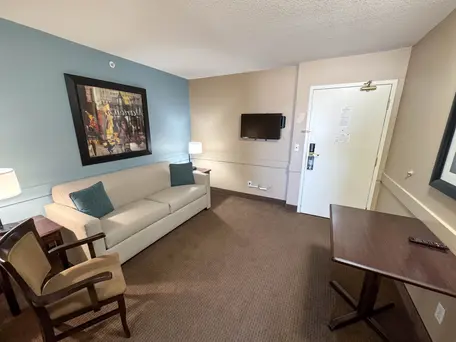 Comfortable suite with separate living room and seating area at Super 8 Edmonton South, ideal for extended stays.