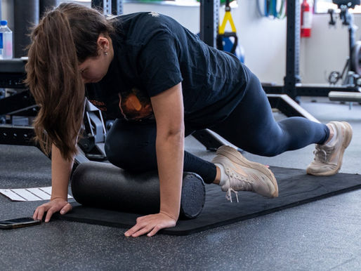 EVO Health and Performance coach working with a client on foot and calf strength for heel and plantar fascia pain