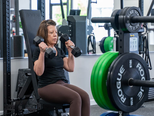 Athlete lifting weights at EVO Health + Performance to apply progressive overload