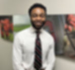 A business professional smiling in the hallway of Ohio State University Physicians' corporate office.