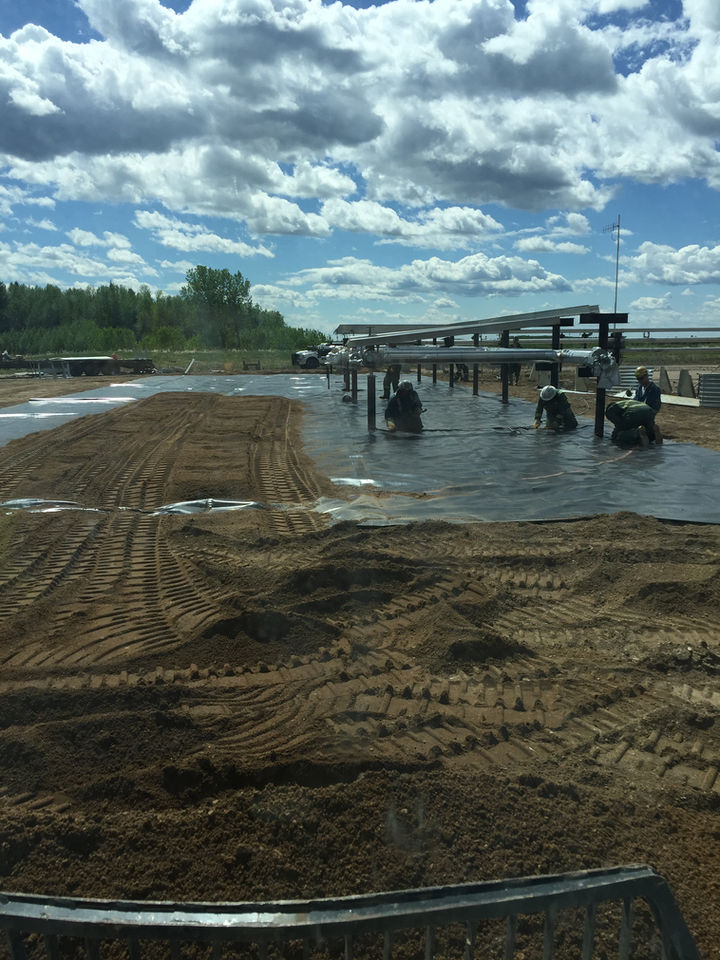 A picture showcasing workers working on an oilfield site