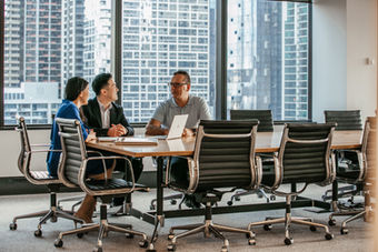 Business team meeting around table, city view