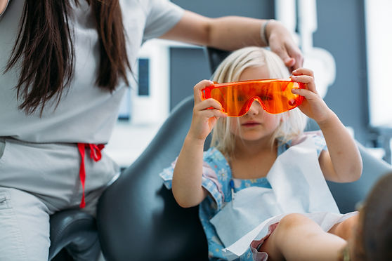 Girl at dentist, wearing protective eyewear