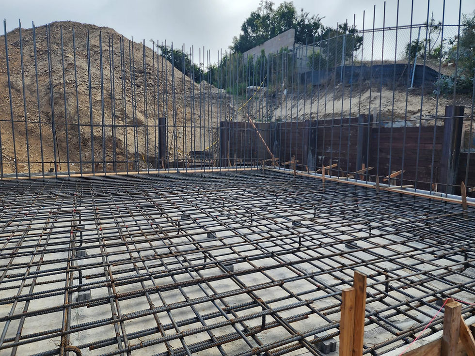 Mat slab for a basement, pre-pour, showing the reinforcement layout and preparation for a strong foundation.