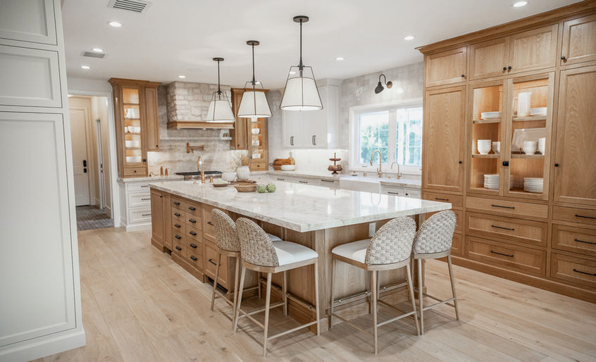 Spacious modern farmhouse kitchen with marble island, wood cabinetry, and pendant lighting in a full house remodel in unincorporated Agoura Hills, Los Angeles County.