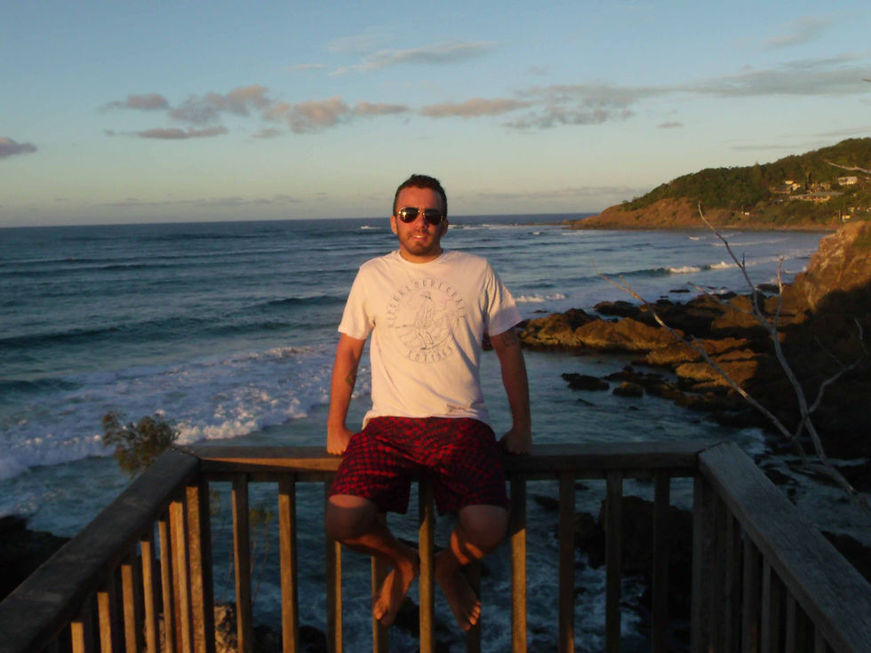 Looking out from a clifftop lookout in Byron Bay, Australia, with the beach and ocean in the background - a quiet moment during my years living in Australia.