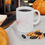 Thumbnail: Coffee mug with Halloween design, on table with candy