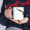 Thumbnail: Person holding colorful rainbow design mug