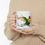 Thumbnail: Person holding mug featuring colorful parrot