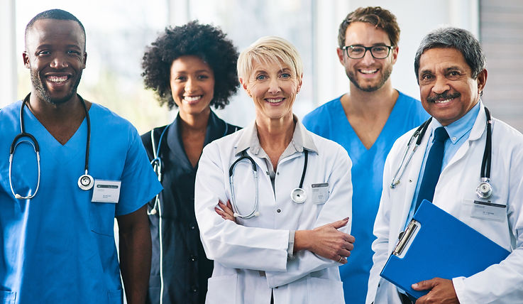 Team or group of a doctor, nurse and medical professional colleagues or coworkers standing