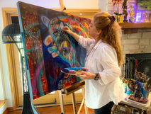 Madhavi Devi working on her painting Imagine #5 in her studio.