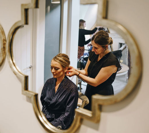 Sam Kerr Bridal Hair creating a low chignon bun. - Surrey Wedding hair stylist - Cotswold's wedding
