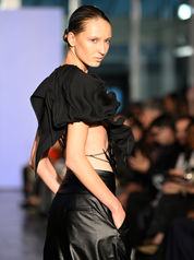 model in black on a fashion runway in Paris