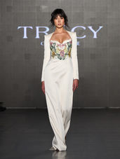 runway model with white outfit on a black and gray background