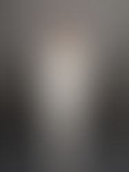 runway model with white outfit on a black and gray background