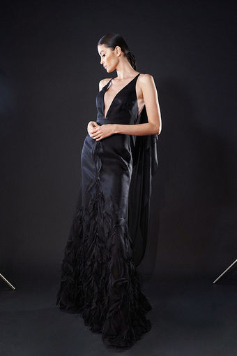 A female model wearing a black dress designed by Macario Jimenez 