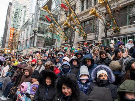 Spectators viewing the Chicago Thanksgiving Parade from VIP area