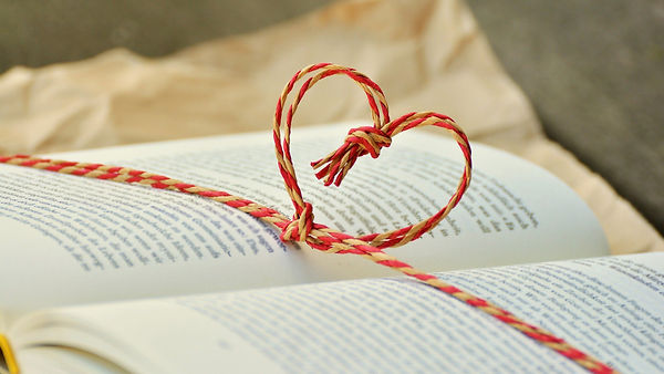 Knotted String Heart over an open book